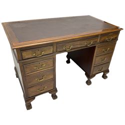 Early 20th century mahogany twin pedestal desk, fitted with nine drawers, on ball and claw carved cabriole feet