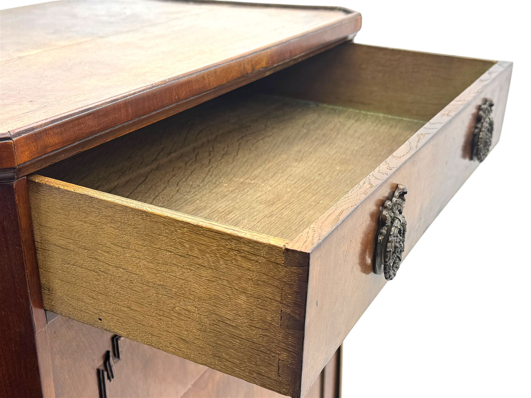 Early 19th century walnut secrétaire, rectangular top above full width drawer, hinged writing surface with green leather inset enclosing small drawers and shelves, lower section fitted with double cupboard enclosing additional shelves and drawer, raised on bracket feet with scalloped apron