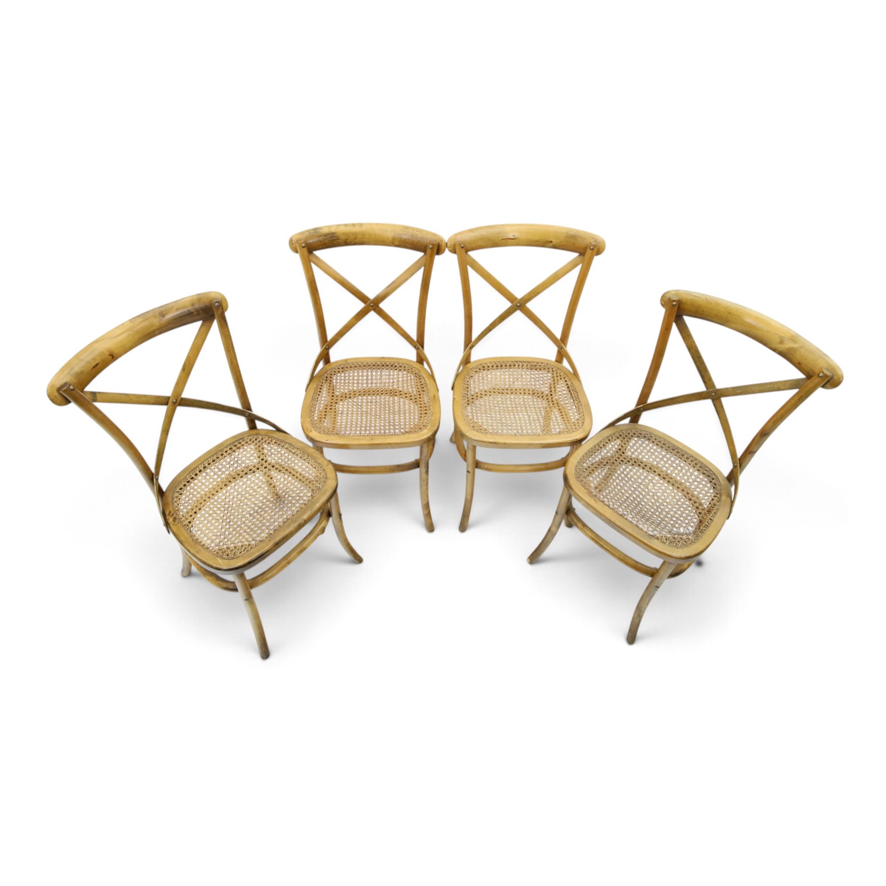 Set of four Oka style rattan dining chairs, bentwood frames inset rattan seat