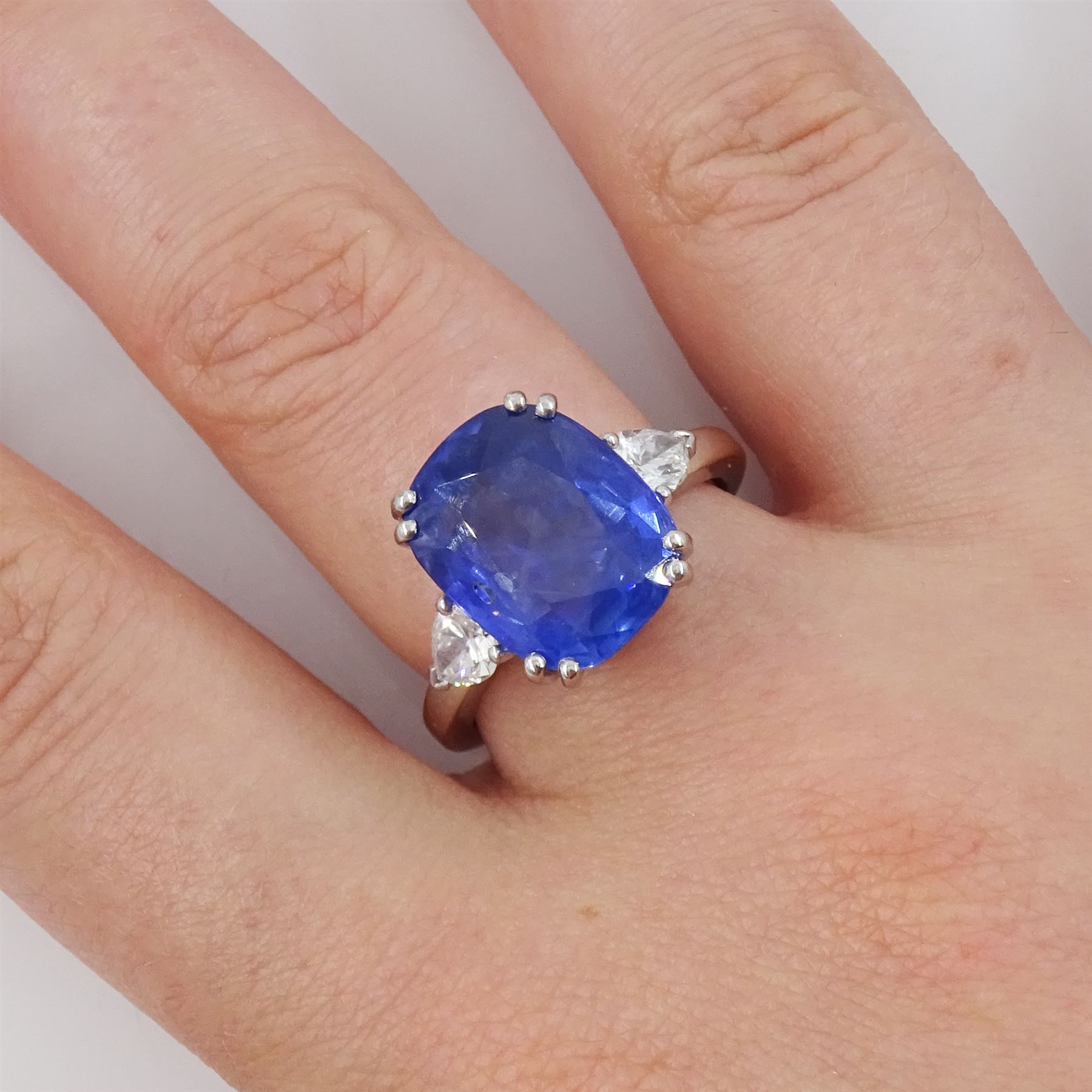 French 18ct white gold and platinum three stone unheated Ceylon sapphire and diamond ring, the single mixed cushion cut sapphire of 8.49 carat, with Gem Paris report, flanked by pear cut diamonds, hallmarked, total diamond weight approx 0.60 carat