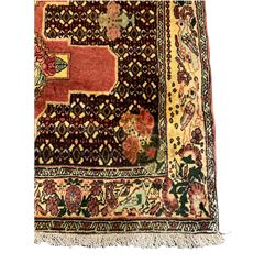 Kurdish pink ground runner, set with a series of ten floral medallions on linked field, the border decorated with stylised flower heads and bird motifs 