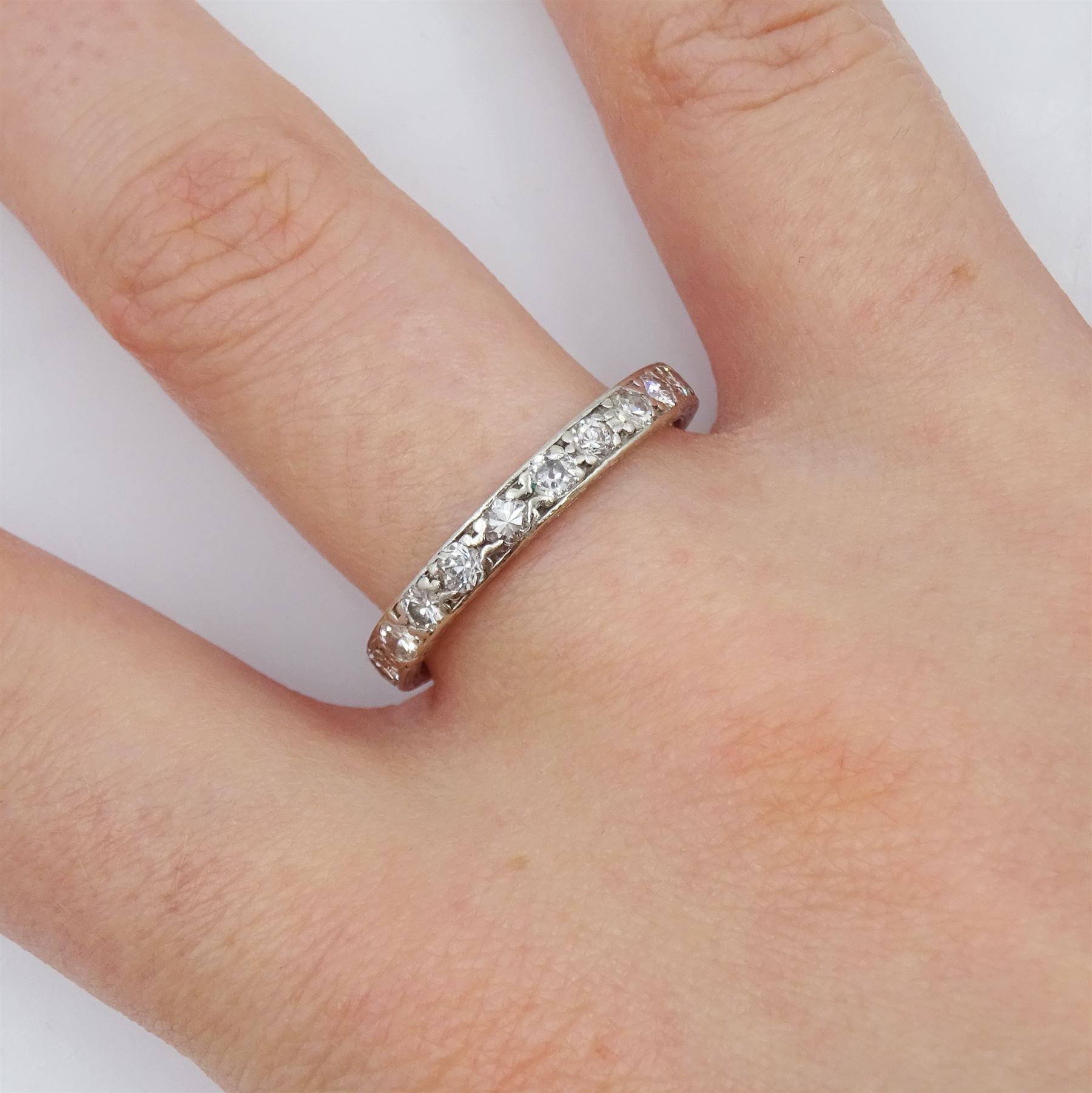 Early-mid 20th century platinum channel set diamond full eternity ring, the band with engraved decoration, total diamond weight approx 0.90 carat