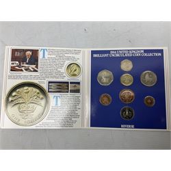 The Royal Mint United Kingdom 1984 brilliant uncirculated coin collection, 1997 and 2001 commemorative crown coins, 1997 old round one pound, all in card folders and four sterling silver medallic first day covers from the 'Great Britons' collection housed in a blue folder