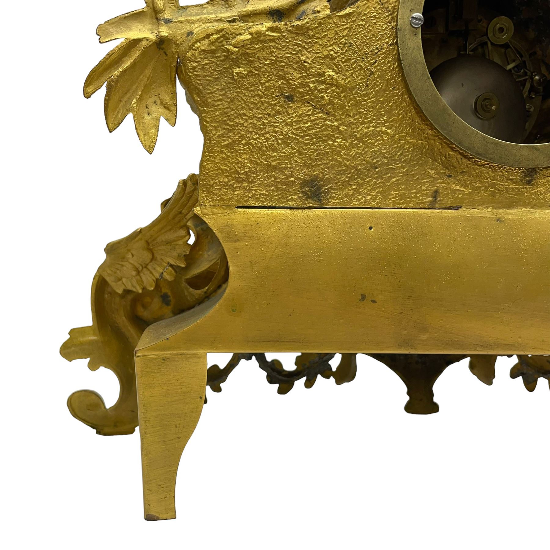 French - late 19th century 8-day gilt spelter mantle clock retailed by J Vassalli of Scarborough c1890, sculptured with an oriental 16th century representation a Mughal warrior slaying a leopard, raised on a profusely  decorated base with scroll work and splayed feet, white enamel dial with Roman numerals, minute track and steel hands, Parisian twin train countwheel striking movement, striking the hours and half-hours on a bell. With pendulum & Key.  