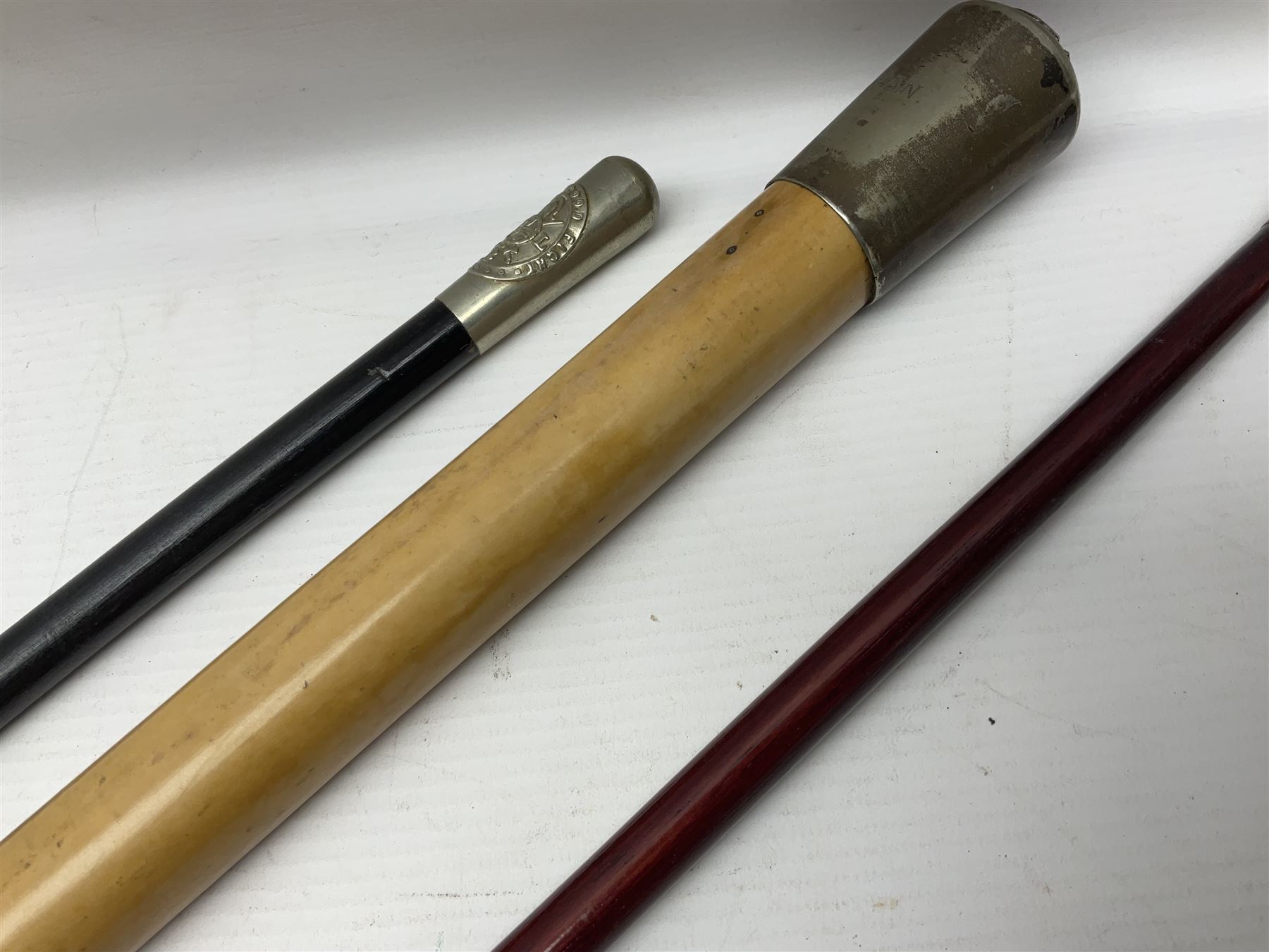 Three parade ground canes - malacca cane Coldstream Guards with plated mount engraved 'H.A. Myhan' L87cm; ebonised Church Lads Brigade 'Fight The Good Fight'; and mahogany stained Worcestershire Regiment (3)