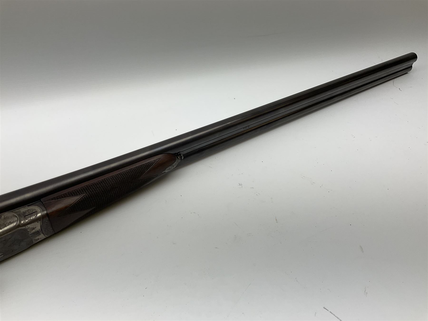 Harrods Ltd. Brompton Road London (Retailer) 12-bore side-by-side boxlock non-ejector sporting gun, 75cm barrels, walnut stock with chequered grip and fore-end and thumb safety, serial no.015, L118.5cm overall SHOTGUN CERTIFICATE REQUIRED