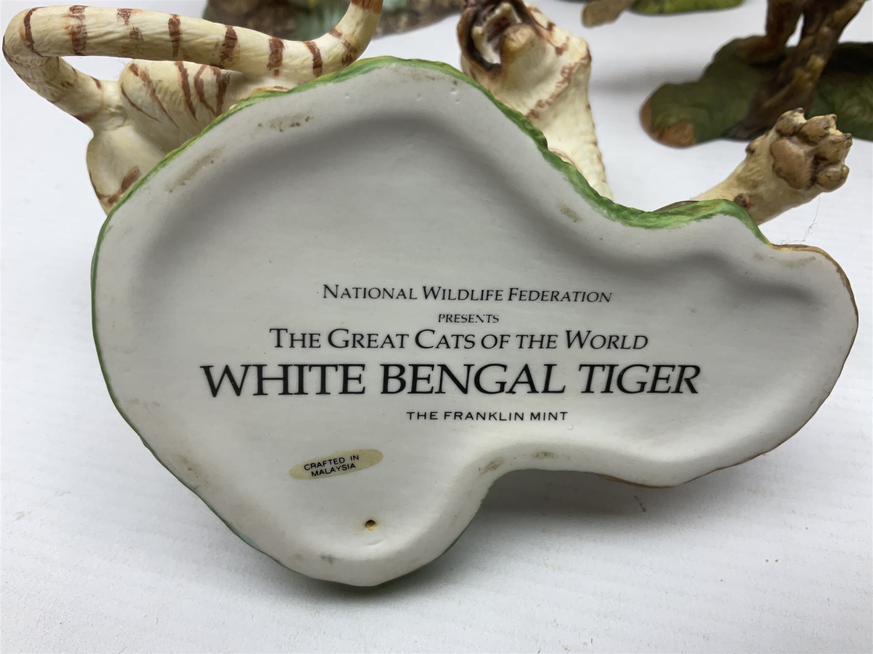Ten Franklin Mint National wildlife Foundation Big Cats of the World figures to include, White Bengal Tiger, Jaguar, Cougar, Cheetah, Clouded Leopard etc, with display stand