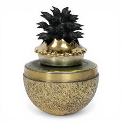Late 20th century silver and silver-gilt surprise egg, the textured gilt exterior opening to reveal a clutch of chicks, the clustered heads supported upon a spring, within a jagged and lobed silver and gilt encasement, with green enamel surround, hallmarked Stuart Devlin, London 1982, H7cm