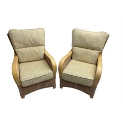 Contemporary rattan conservatory suite - two seat sofa with wicker frame and loose cushions upholstered in textured champagne fabric (W125cm H98cm); pair of matching armchairs (W72cm H98cm); rectangular glass-topped coffee table with rattan frame and undertier (W85cm D60cm H47cm); and matching square side table (W53cm H55cm)