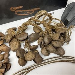 Collection of traditional necklaces from the Solomon Islands, including shell and boar tusk examples, together with a carved canoe prow, with mother of pearl eyes, painted cow hide and a copper plaque, depicting the Solomon Islands, with presentation engraving