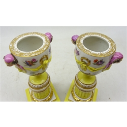  Pair of Berlin Porcelain Urn Shaped Candlesticks Vases, painted with figure in landscapes with female head handles and drapery, on stepped column and bun feet, blue Scepter mark, H28cm (2)  
