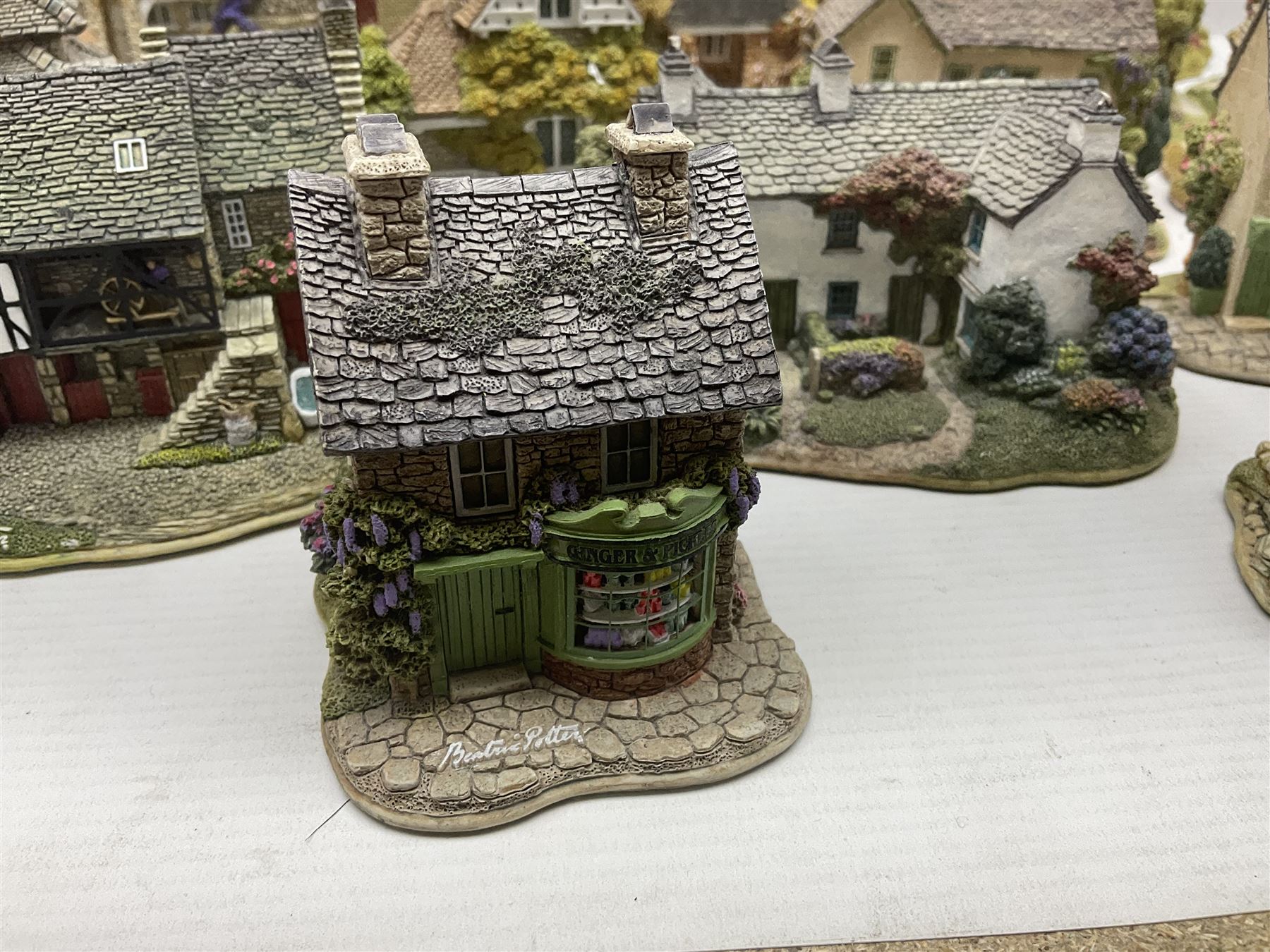 Eight Lilliput Lane limited edition Beatrix Potter models, including Buckle Yeat, Tabitha Twitchits Shop and Ginger Pickles Shop, together with twelve Lilliput Lane models from the Blaise Hamlet collection, including Dial Cottage, Diamond Cottage and Vine Cottage, all with deeds and original boxes (20)