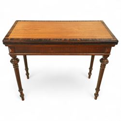 19th century mahogany fold-over card table, the crossbanded rectangular top opening to reveal an inlaid games centre with chessboard and backgammon designs, raised on turned and reeded legs with extending rear supports