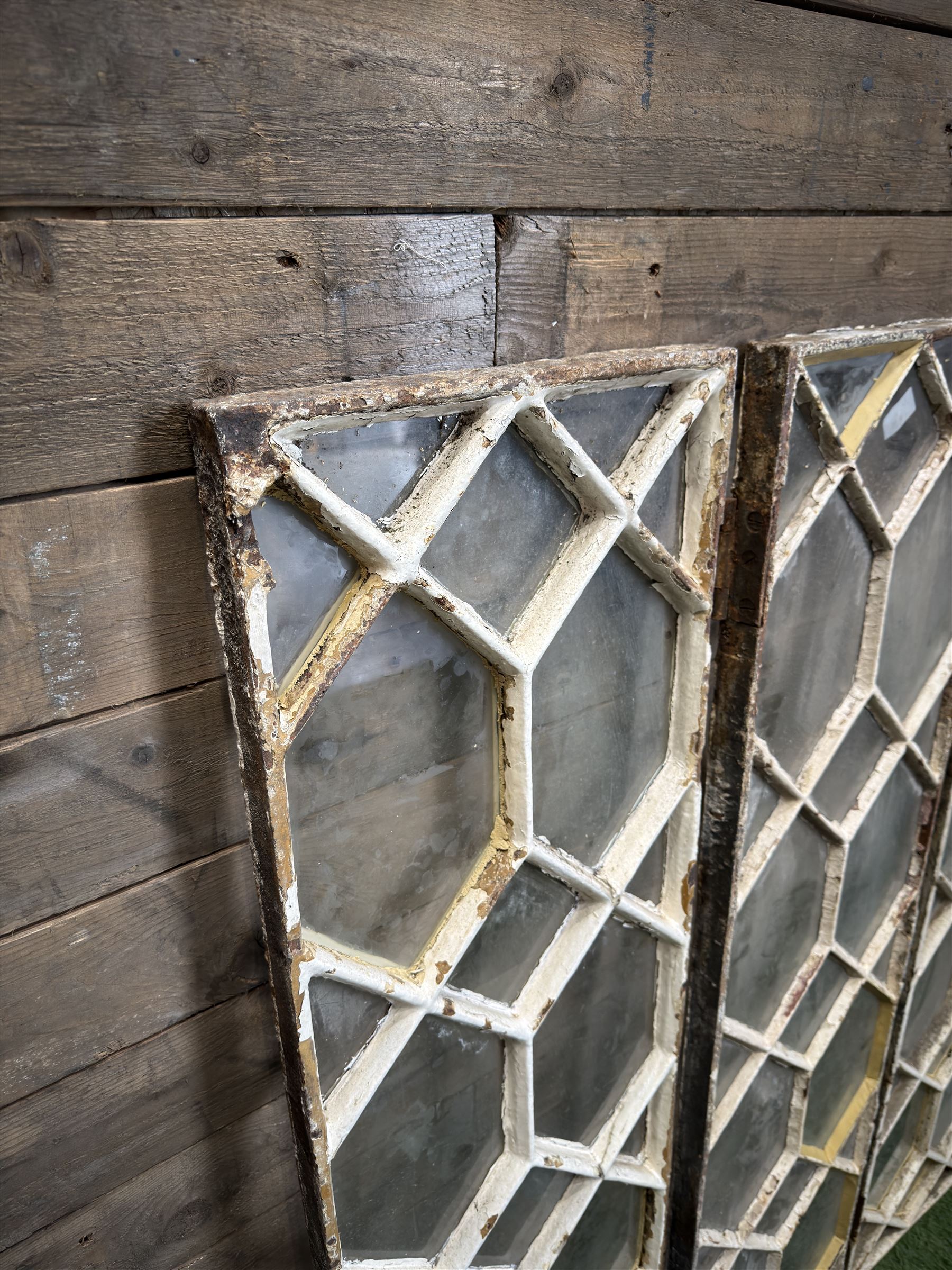Four 19th century cast iron windows, lattice glazed in white painted finish, 