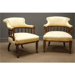  Pair Edwardian walnut tub shaped armchairs, turned gallery back upholstered in damask fabric, turned supports   