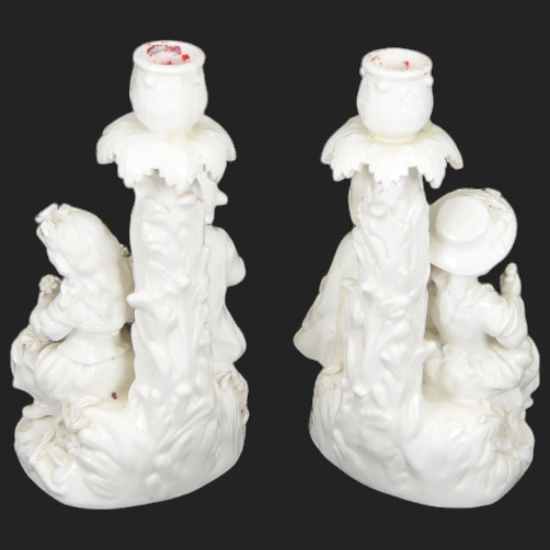 Pair of 19th century Meissen style Blanc de Chine figural candlesticks, each depicting children gathering flowers, with spurious mark beneath, H21cm