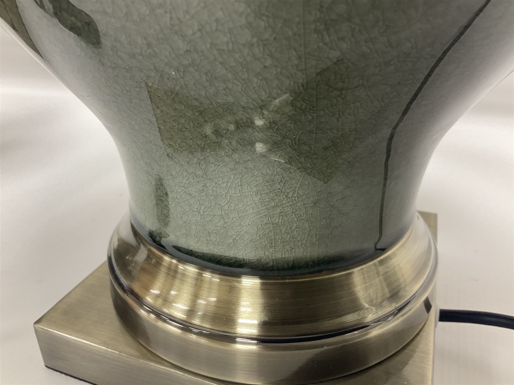 Pair of table lamps of squat baluster form, with a crackle glaze to a dark grey ground, upon a square base, including shade H57cm