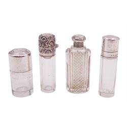 Four silver mounted glass scent bottles, including a Victorian cut glass example with embossed silver cover, and three cylindrical plain glass examples, on with engine turned decoration, three with glass stoppers, together with a pair of silver salts and spoons, all hallmarked, tallest H8cm