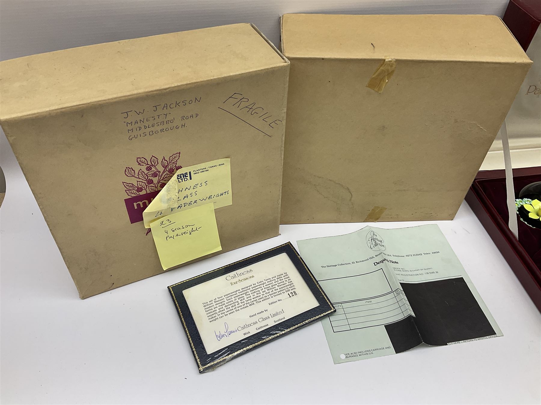 Set of four Caithness paperweights titled Four Seasons, in presentation box with certificate, designed by Colin Terris and made by William Mason, each internally decorated with a seasonal flower within a millefiori cane work garland, numbered 128 of 500