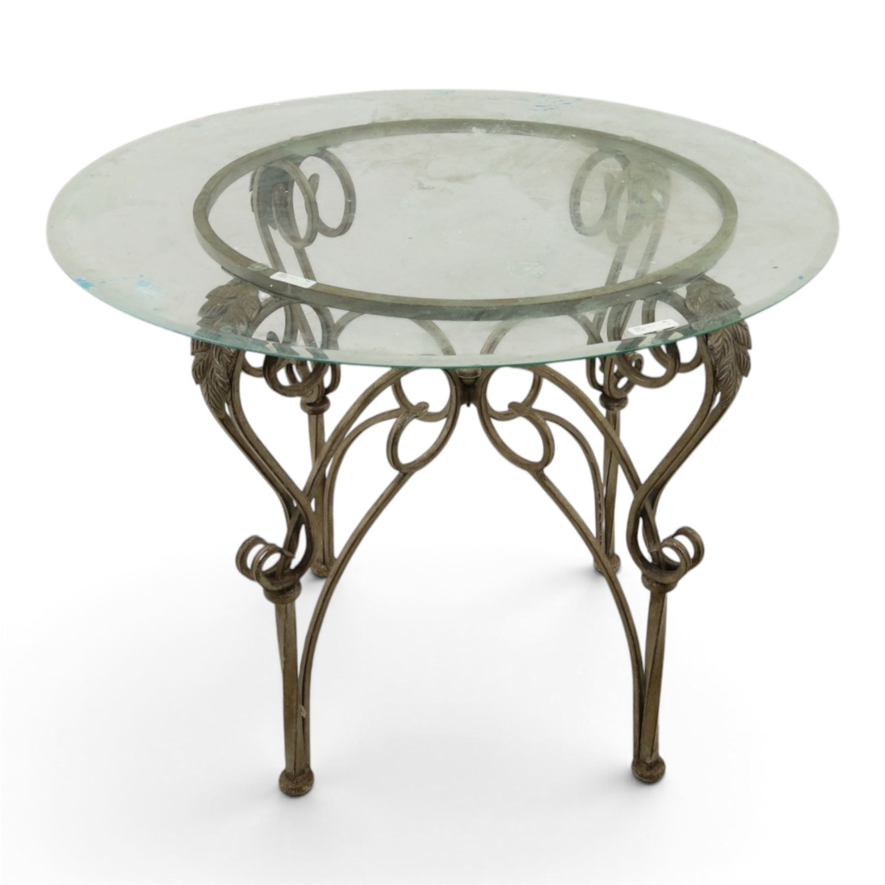 Wrought metal and glass table, with silvered foliate and scrolled design