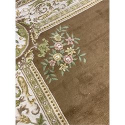 Large woollen carpet, hazel ground field decorated with floral central medallion and spandrels, scrolling foliate border with guard bands