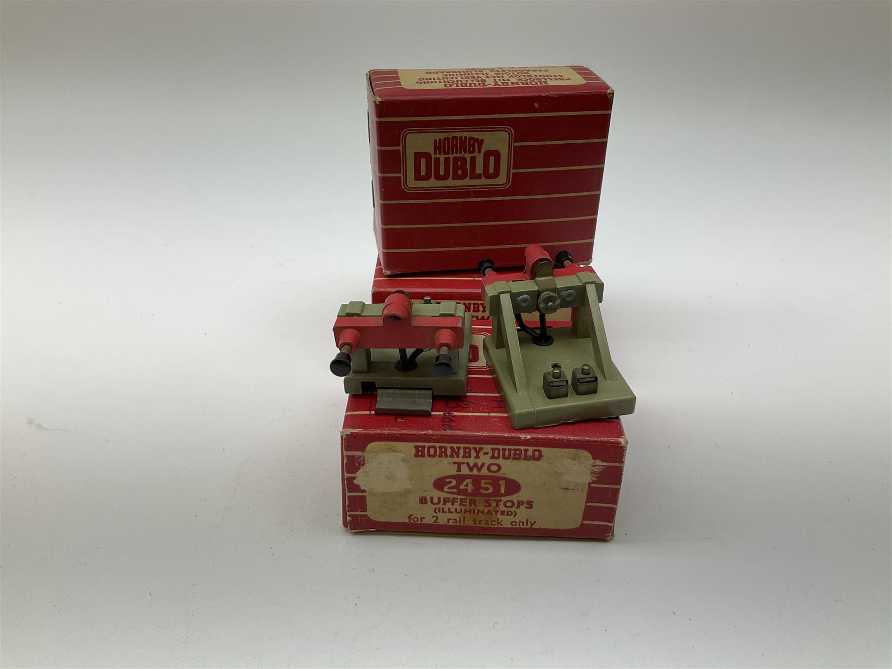 Hornby Dublo - twenty-three pairs of buffer stops including three pairs of 2451 Illuminated for two-rail track; five pairs of 3450 for three-rail track only; and fifteen D1 pairs; all boxed; and two odd loose buffers (21)