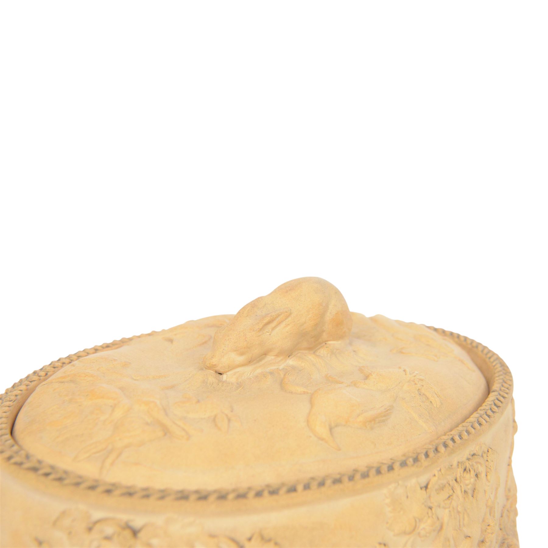 Wedgwood caneware game tureen, the cover with rabbit handle surrounded by country animals, repeating moulded leaf rim, the external sides decorated in light relief with dead game among vines, impressed marks to base, W26.5cm 
