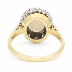 18ct gold opal and diamond cluster ring, oval cabochon cut opal surrounded by twelve single cut diamonds, London 1988