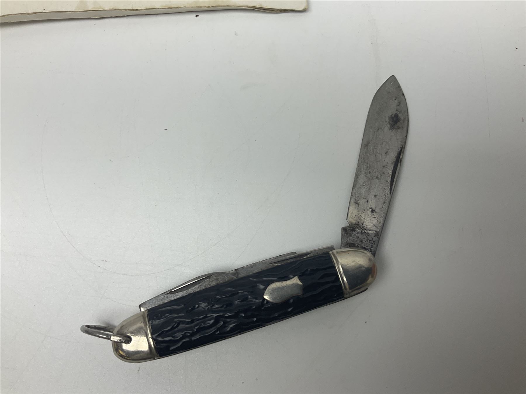 Seven pen knives, two lighters, including one Ronson example and a collection of postcards