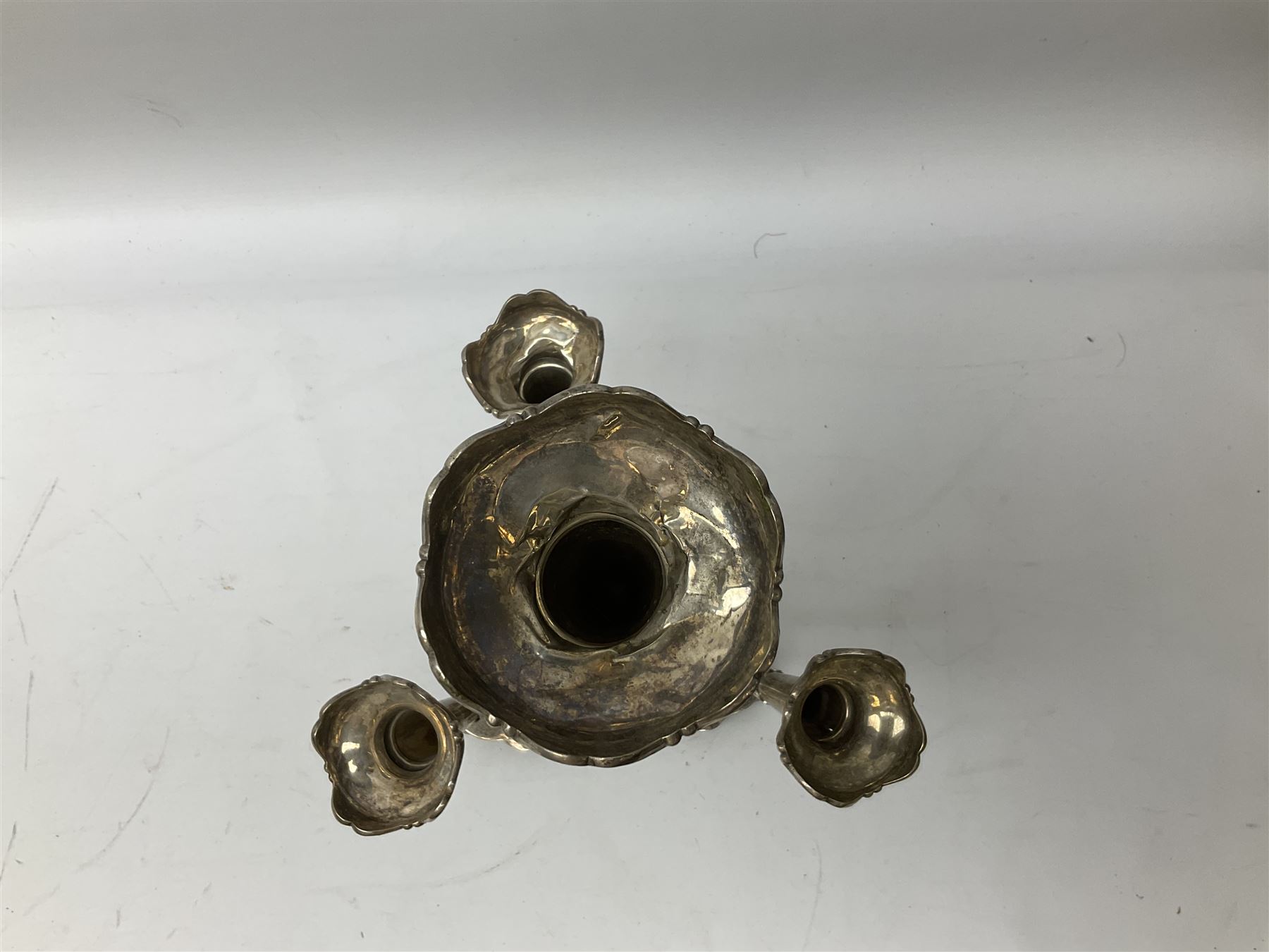 Four hallmarked silver trumpet vases, total weight 108g, upon silver plated stand with foliate decoration and bun feet