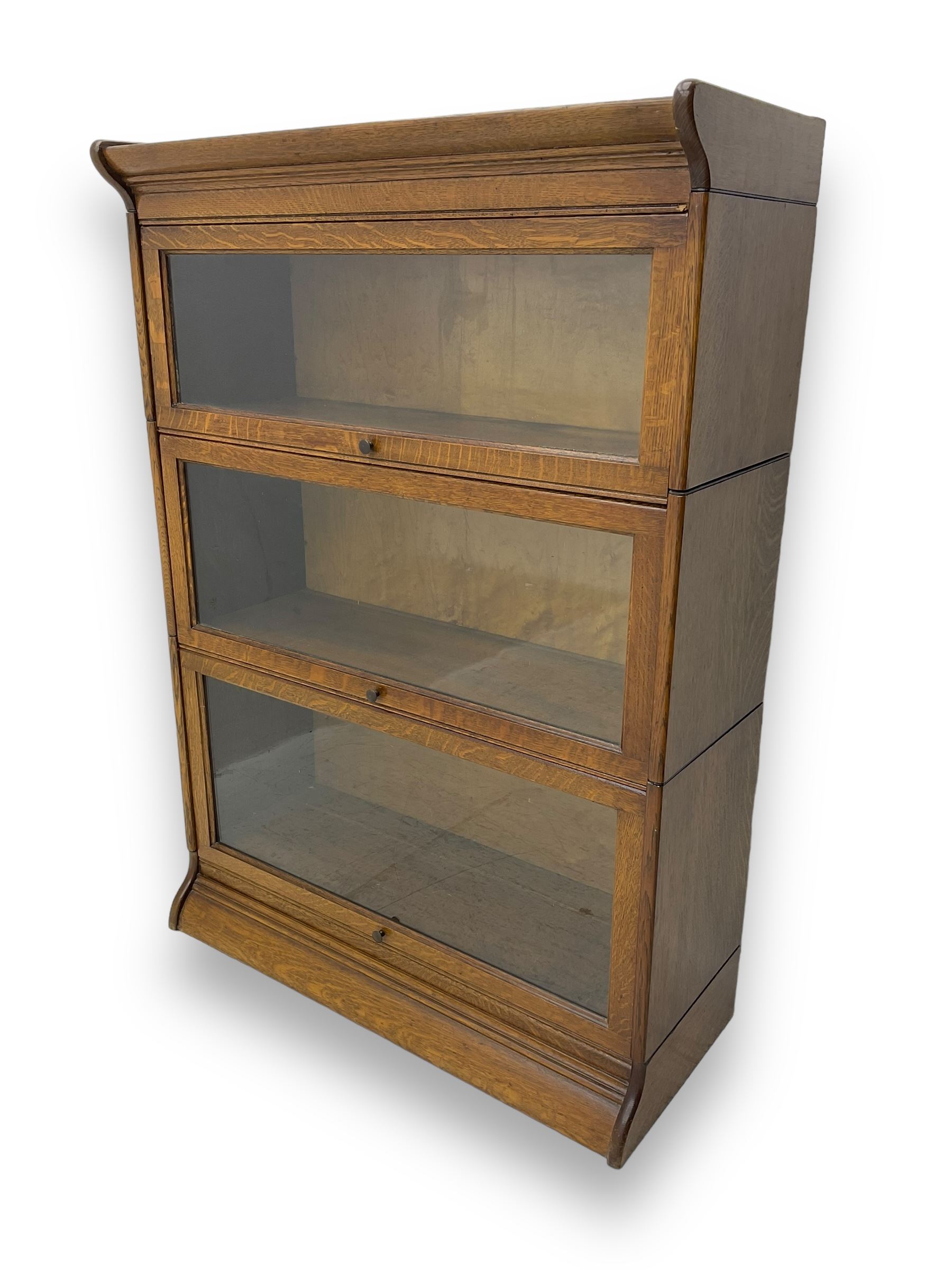Early 20th century oak three-tier stacking library bookcase, enclosed by hinged and sliding glazed doors
