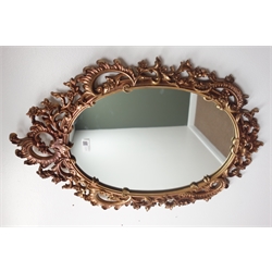  Oval ornate scrolled gilt framed mirror (48cm x 72cm), and another oval mirror (55cm x 65cm)  