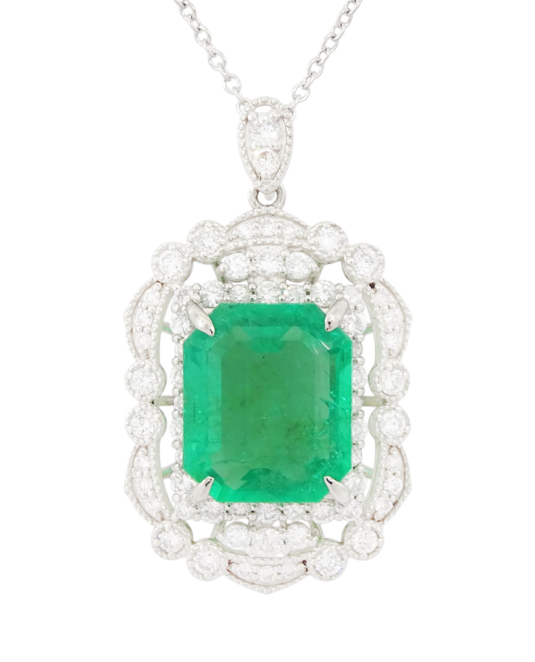 Platinum Colombian emerald and diamond pendant necklace, single octagonal cut emerald of 7.38 carat, surrounded by round cut diamonds in a fancy milgrain pierced design setting, stamped Pt 950, on a trace link chain necklace, total diamond weight 1.14 carat, with GCS certificate
