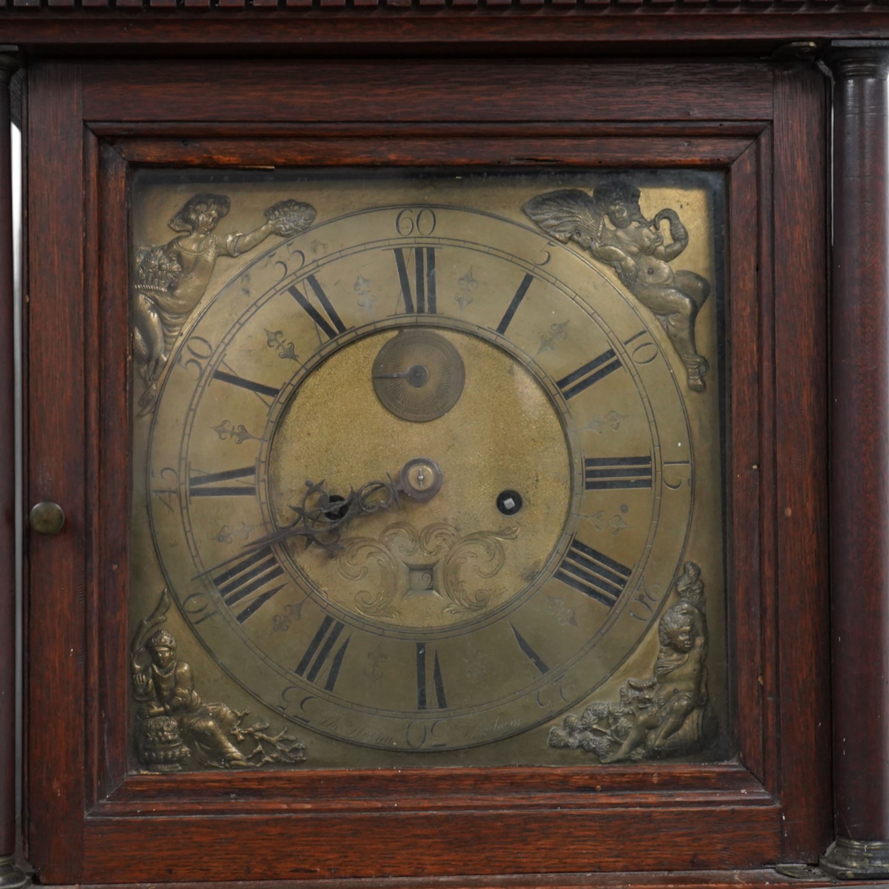 Thomas Holme of Hexham- mid 18th century 8-day oak longcase clock with a swan necked pediment and ball and spire finial to the centre, square hood door flanked by turned pilasters with brass capitals, trunk with canted corners and a long door with a gothic arched top, square plinth raised on an applied skirting, brass dial with 