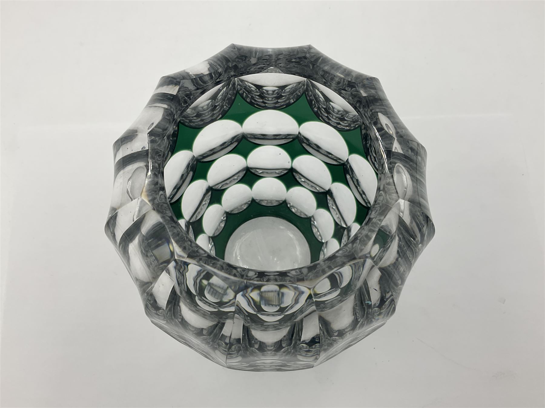 Val St Lambert style glass vase of shouldered ovoid form, cased in deep green over clear and heavily cut with repeat spherical pattern, indistinctly signed beneath ('Jac E. Dalmley'?), H15cm