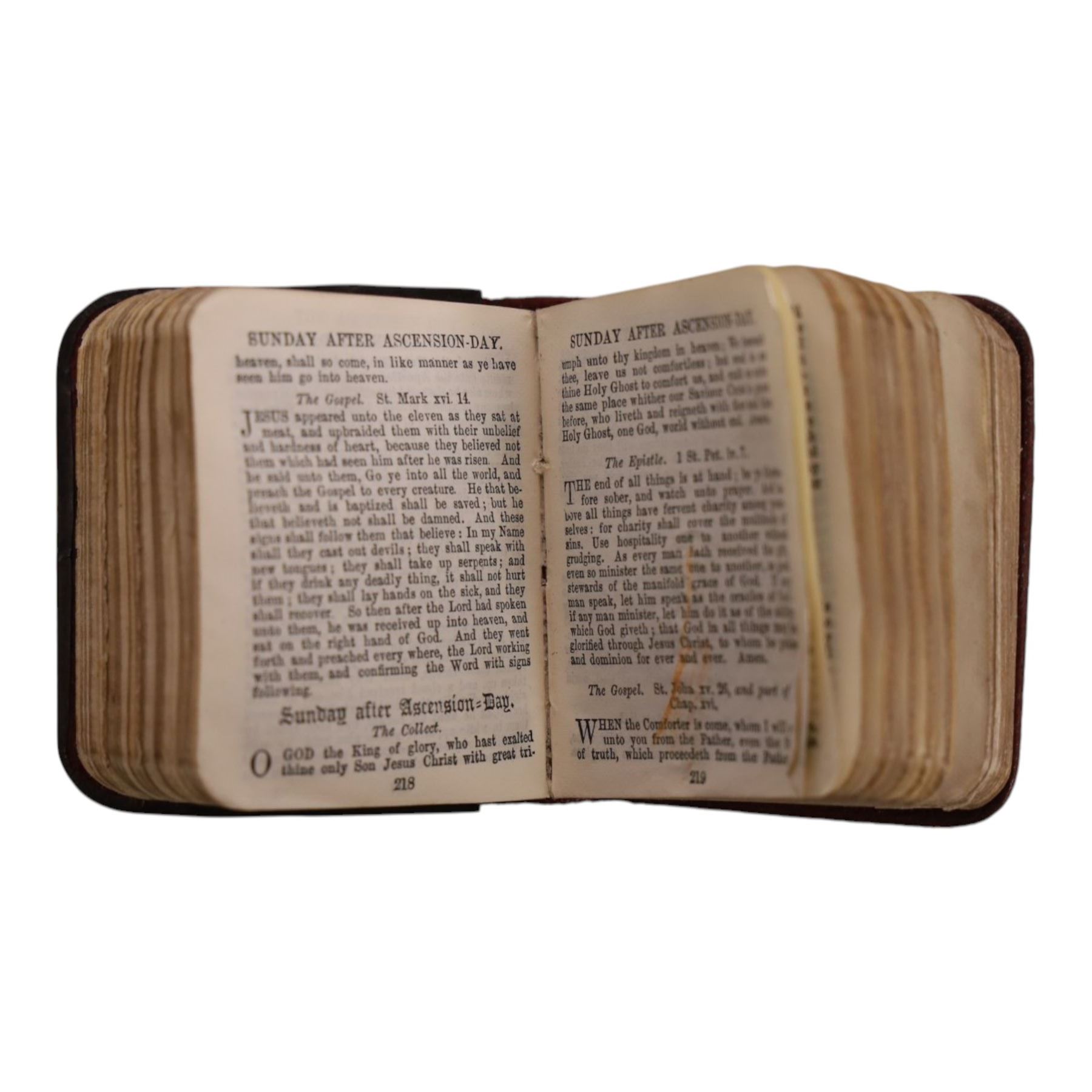 Miniature common prayer book with silver cover, hallmarked, together with brass letter clip if the form of a vine leaf, together with another letter clip in the form of a hand