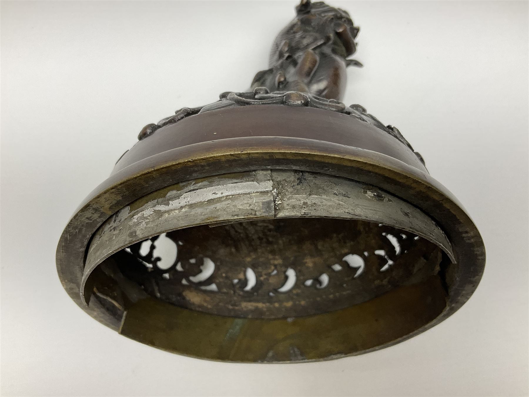 Japanese bronzed koro, the body of globular form with twin cast zoomorphic mask handles, decorated in relief with birds upon blossoming branches, against a ground incised with rushes and peonies, the flat toped domed cover with pierced band and surmounted by a cast figure of a Foo dog, the whole upon three zoomorphic mask feet, with impressed character type mark beneath, H35.5cm
