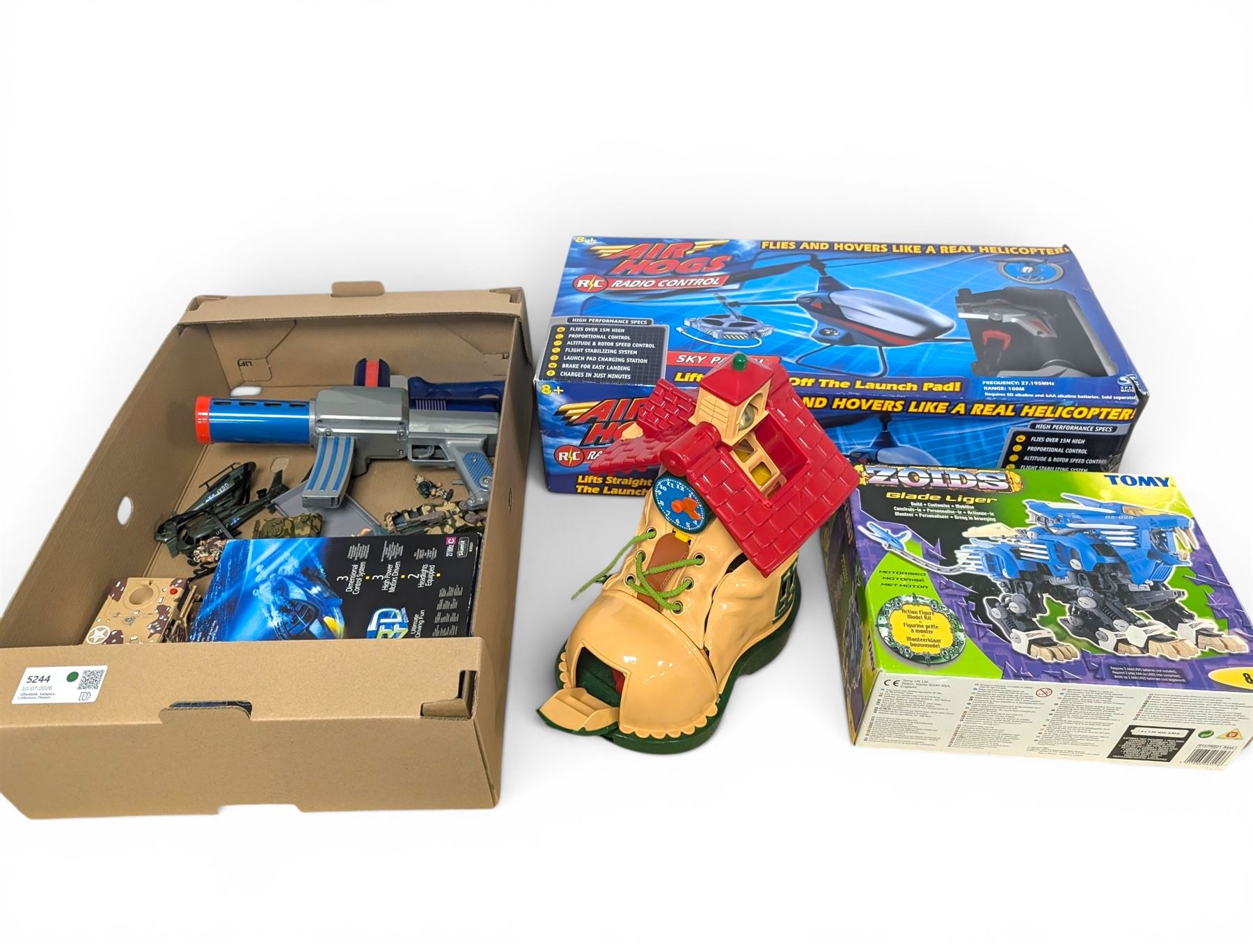 Collection of toys, including Matchbox Old Mother Hubbard's shoe, Tomy Zoids Blade Liger, Air Hogs radio controlled helicopter, diecast tanks etc, 
