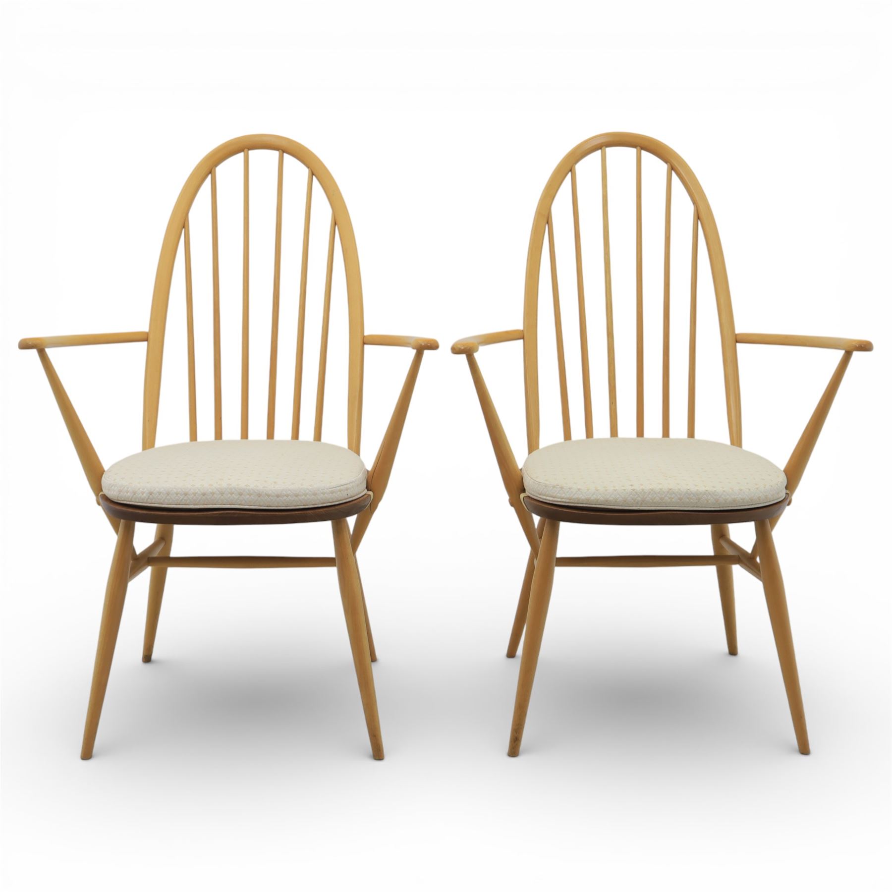 Ercol - elm dining chairs, set of six including two armchairs, arched spindle backs over shaped elm seats with upholstered pads, tapering beech legs joined by stretchers