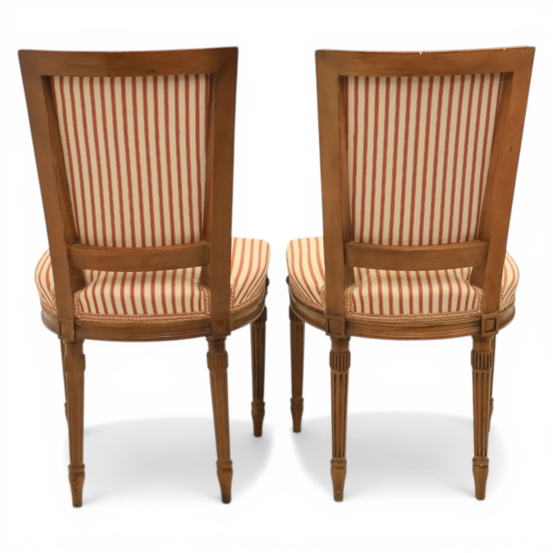 20th century Louis XVI style beech salon suite, comprising settee and four chairs, the settee with shaped rectangular back and upholstered arms over a shaped seat, the chairs with rectangular backs and overstuffed seats, each upholstered in striped fabric with close-nailed borders, upon fluted tapering supports headed by carved paterae, terminating in toupie feet, chairs H89cm W47cm