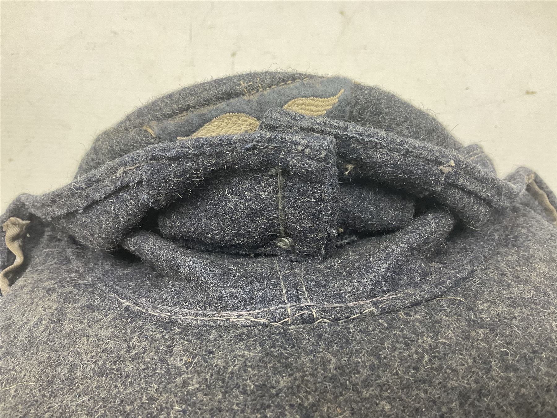 WW2 German Luftwaffe M43 field cap with triangular cloth eagle and roundel badge; marked '1944 ?/0501/0015 57'