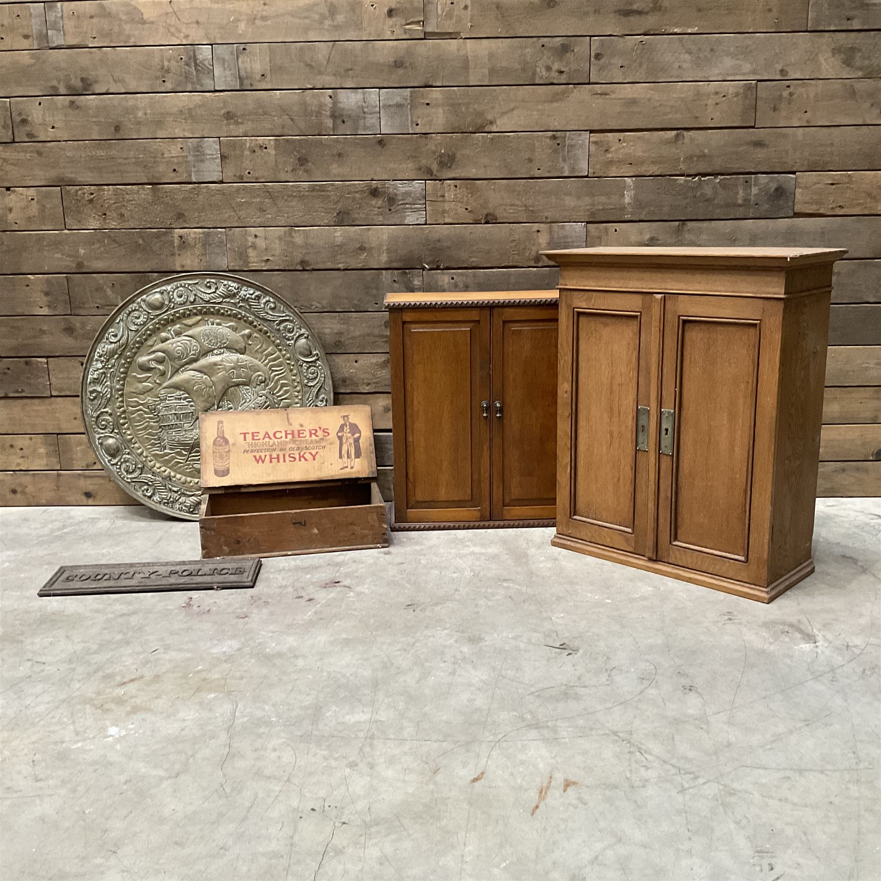 Whisky box, cast iron police sign, embossed brass wall hanging, two small oak cabinets