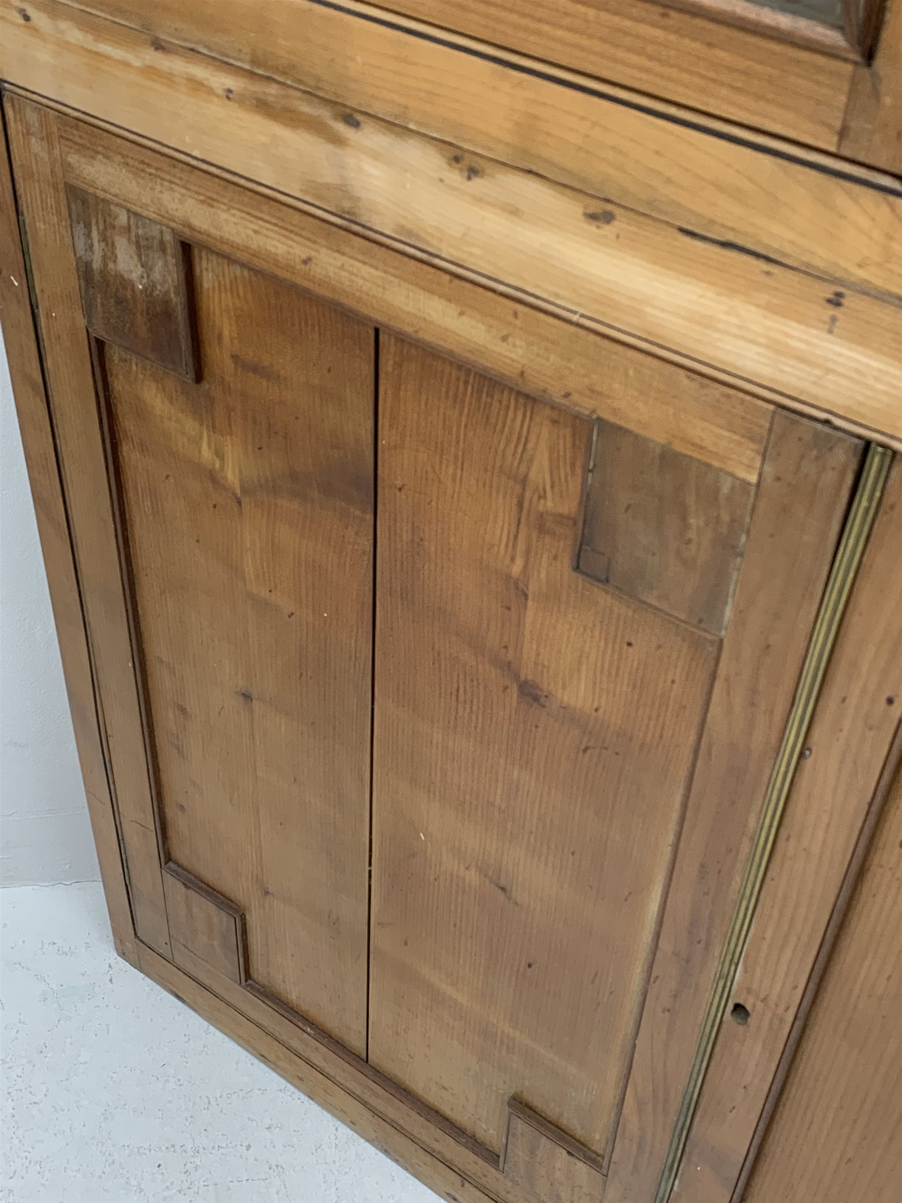 Large late 19th century sycamore corner cabinet, the top section with two astragal glazed doors enclosing two shaped shelves, the lower section enclosed by two panelled doors with square spandrels, W128cm, H215cm