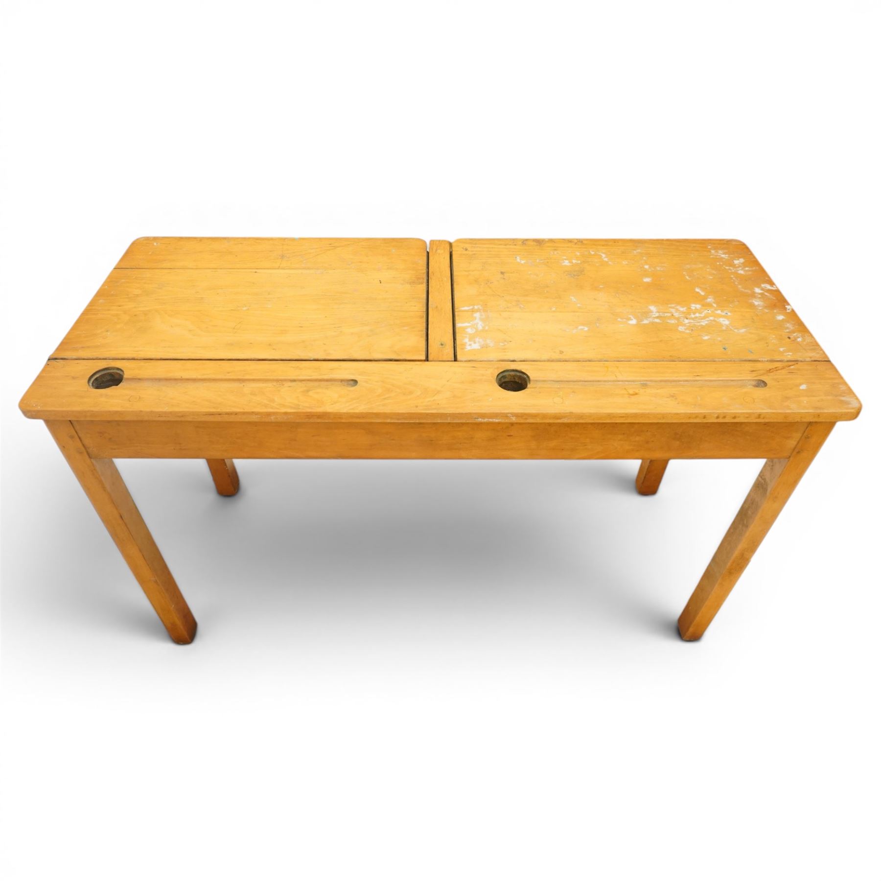 Mid-20th century beech double school desk, twin hinged desk-top compartments with inset pen and ink tray, on square supports