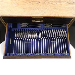 Ealy 20th century oak canteen, with five drawers behind double doors, four drawers containing a part set of silver plated Hanoverian pattern cutlery with engraved monograms and a set of twelve mother of pearl handled fruit knives and forks, the last drawer containing a collection of loose silver plated cutlery, canteen H39cm, W48cm