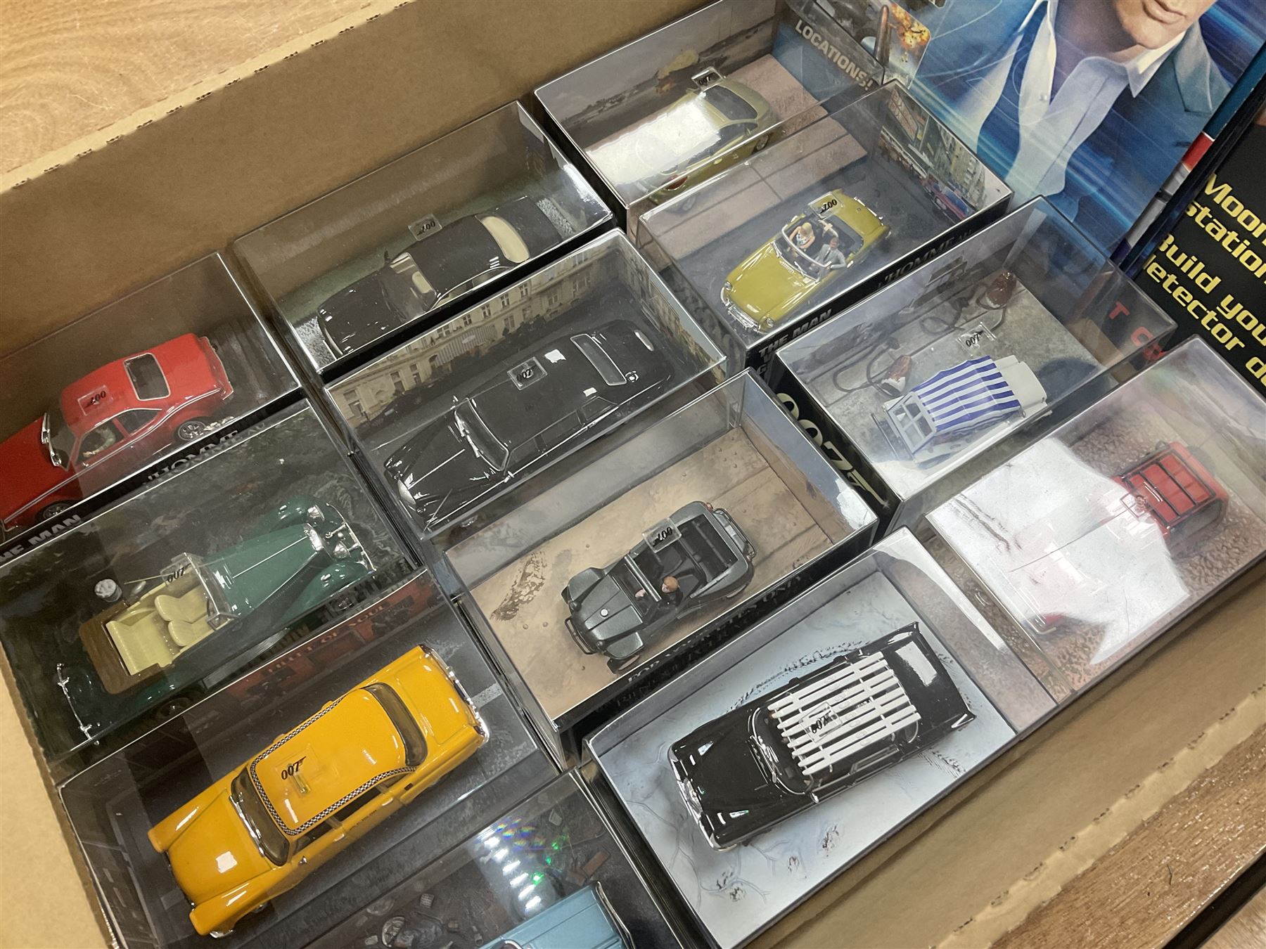 Fabbri James Bond Collection - over one hundred and ten die-cast models in perspex display cases as issued periodically; and a quantity of associated magazines and trading cards, in five boxes