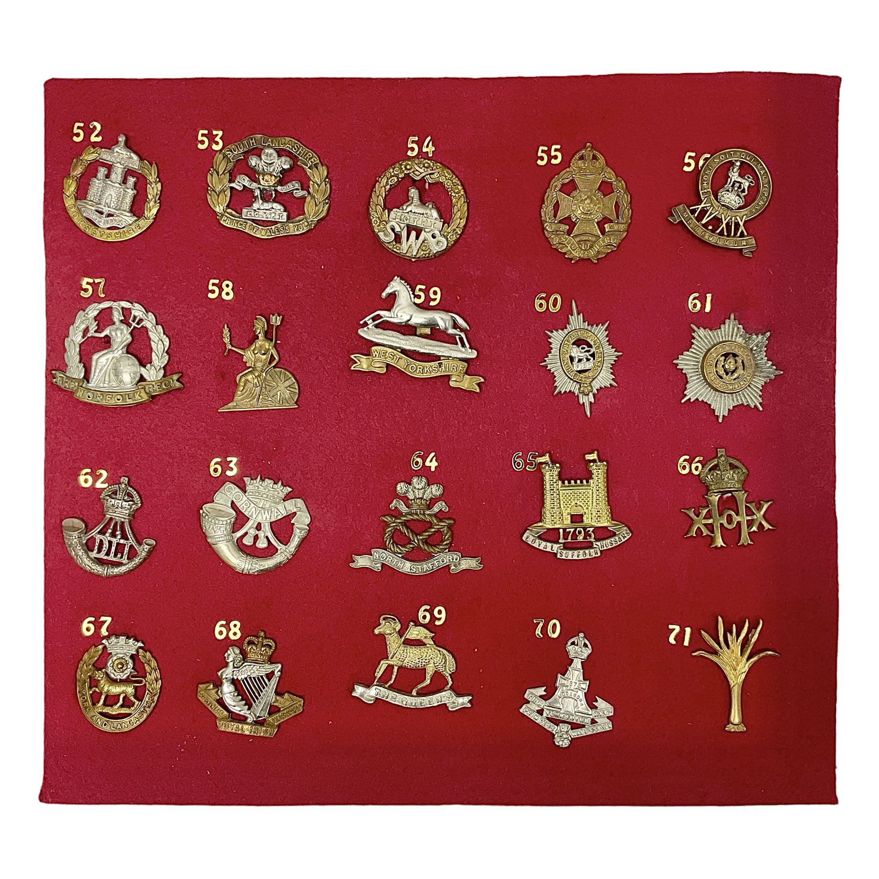 Twenty cap badges including Welsh Guards, Kings Royal Irish Hussars, York & Lancaster,  Loyal Suffolk Hussars, North Stafford, Durham Light Infantry, Cheshire, West Yorkshire, Norfolk, South Wales Borderers, Dorsetshire etc; mounted on a board for display