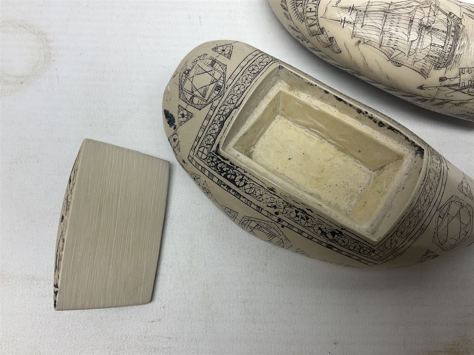 20th century resin carvings in the style of scrimshaws the first example depicting Ship Mercury, the other with a removable top, tallest example H10.5cm