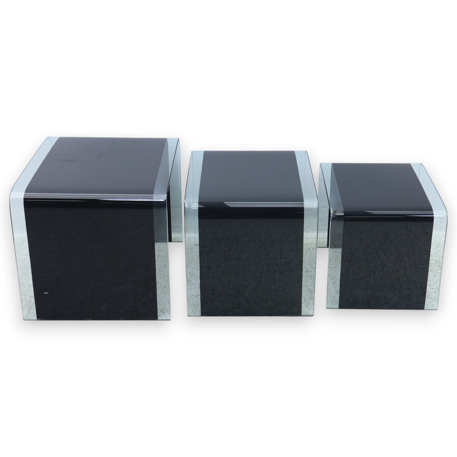Nest of three contemporary glass occasional tables, black glass centres with  clear glass borders 