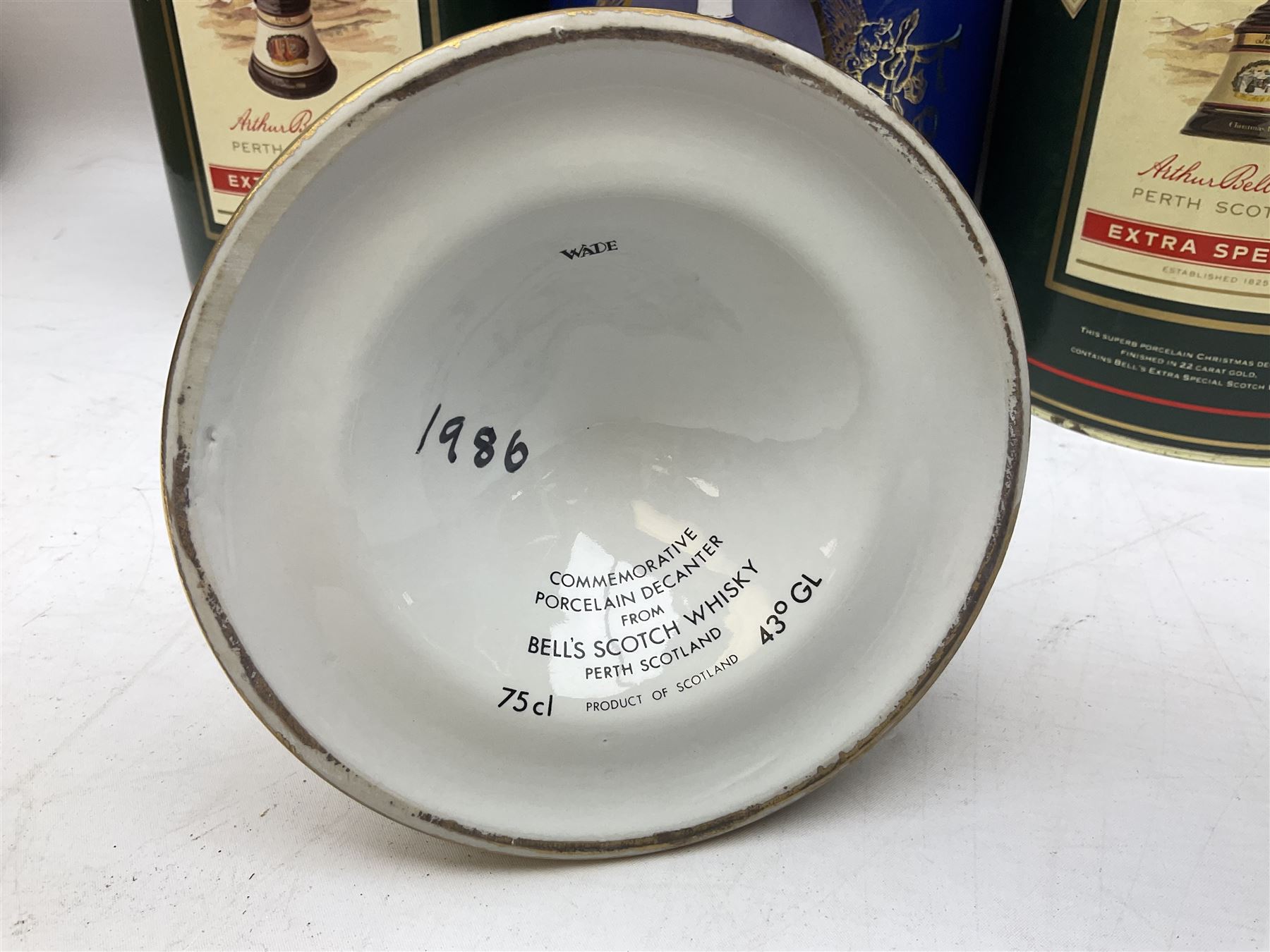 Bells, Scotch whisky, in seven Wade ceramic decanters, comprising two Christmas decanters 1990 and 1991, 60th birthday of Queen Elizabeth II decanter, Golden Wedding anniversary of the Queen and the Duke of Edinburgh decanter, Birth of Princess Beatrice decanter, Birth of Princess Eugenie decanter and Queen's mothers, together with Bells, blended Scotch whiskies, three miniatures in Wade ceramic decanters, various contents and proofs